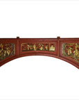 Red and gold wooden sign with hand-carved scenes of people and landscapes.