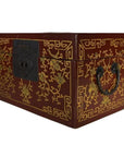 Close-up of red and gold lacquer antique Chinese box with central latch, stylized bird design, ornate handles.