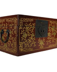 Black and gold lacquered Chinese box with central latch, stylized bird design, ornate hand-carved gilt patterns, close-up.