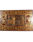Black lacquered wood box with central latch and stylized birdwork design, close-up.