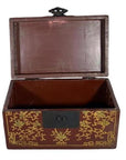 Black and gold lacquer box with gilt stylized bird designs, central latch, ornate exterior, shown on plain background.