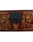 Close-up of red lacquer Chinese box with central latch and stylized bird design on surface.