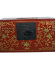 Red lacquer wood box with gilt phoenix and vine design, black metal front latch, close-up.