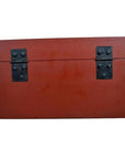 Red lacquer box with gold floral inlay, hinged lid, and two black metal hinges on front, shown against plain background.