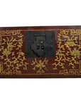 Black and gold lacquer box with gilt floral patterns, scenic lid, and dancing figures, shown close-up.