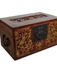 Red lacquered Chinese antique box with gilt floral designs, dancing figures on scenic lid, metal latch, and side handles.