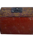 Red and gold lacquered Chinese box with raised scene on lid, metal latch, antique style, shown from front angle.