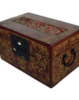Close-up of red and gold Chinese lacquer box with raised top scene, metal latch, and side handle.