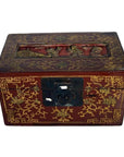 Red and gold lacquered Chinese box with raised top scene and old metal latch, close-up view.