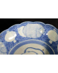 Blue and white ceramic scalloped dish with crouching mouse, barrel cartouche, and aquatic patterns.