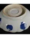 White ceramic scalloped dish with crouching mouse and barrel cartouche, shown upside down on plain background.