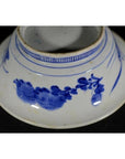 Blue and white ceramic deep plate with broad blue rim and minimal center, viewed from the bottom.