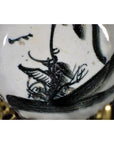 Close-up of white porcelain plate with bamboo branches and calligraphic brushwork in antique ink style.
