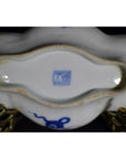 Close-up of blue and brass antique cloud-form dish base with figural scene, showing blue mark and ornate side stands.