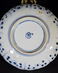 Close-up of the underside of a blue and white porcelain plate with blue circles and a central blue symbol.