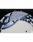Close-up of blue and white antique Chinese porcelain plate with hand painted oxen and lattice border design.