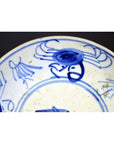 Close-up of antique hand-painted Chinese porcelain plate with Longevity and crab design, partial view.
