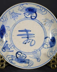 Blue and white hand-painted Chinese porcelain plate with crab design on decorative metal stand.