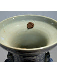 Close-up of an antique Chinese hand-painted vase with a brown wax seal and weathered inner rim.