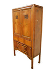 Brown wood Chinese kitchen cabinet with hand-carved framework, two doors, and three drawers, front view.