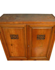 Brown wood Chinese kitchen cabinet with hand-carved framework and two paneled doors, indoor setting.