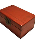Black and red lacquered Chinese antique box with metal latch, resting on a white background.