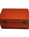 Red lacquered rectangular antique Chinese box with metal hinges, closed on a white background.