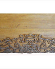 Close-up of a black and red lacquered wood Chinese cabinet with brass hardware and detailed hand-carved dragon motifs.