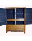 Black lacquered antique Chinese cabinet with brass hardware, doors, and drawers against a light background.