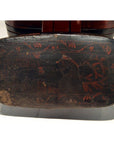 Close-up of hand-painted dark wood lid with red floral designs, part of antique Chinese lacquered tiered food basket.