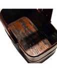 Close-up of a dark-finished antique Chinese lacquered tiered food basket with worn base, empty, shown indoors.