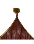 Close-up of pointed tops of antique Chinese large flags with tassels, white background.