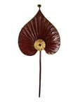 Close-up of two antique Chinese heart-shaped fans, dark red with gold accents, inspired by ceremonial flags.