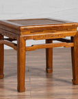 Brown elmwood Ming style side table with horsehoof legs and woven rattan seat, waisted design, close-up view.