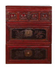 Red and black lacquered antique Chinese chest with three sections, carved figures, and floral panel details.