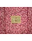 Close-up of red fabric with diamond and flower pattern, inspired by Antique Chinese Red Lacquer Blanket Chest.