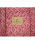 Close-up of red fabric with diamond and flower pattern, inspired by Antique Chinese Red Lacquer Blanket Chest.