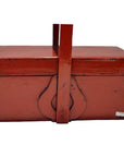 Close-up of antique Chinese red lacquer wood box with tall handle, latch, and worn aged red paint.