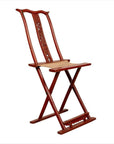 Red lacquered wood folding chair with footrest and fabric, antique Chinese style, on white background.
