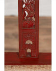 Close-up of red lacquered wood folding chair with footrest and fabric upholstery, antique Chinese style.