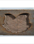 Brown wooden antique Chinese rice mold with lotus symbol, Fu bat motif, and intricate patterns, close-up view.
