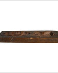 Brown antique Chinese rice mold with carved lotus and fu bat motifs on a plain white background.