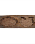 Brown wood antique Chinese rice mold with lotus symbol and Fu bat motif, floral and geometric carvings, close-up view.
