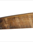 Close-up of weathered wood Chinese rice mold with carved koi fish and lotus blossom designs.
