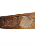 Wooden antique Chinese rice mold with carved koi fish and lotus blossom designs, close-up on white background.
