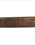 Brown wood antique Chinese rice mold with carved fish and floral medallion motifs, rectangular block, close-up.