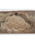 Brown wooden Chinese rice mold with stylized cloud, circular patterns, and radiating lines, close-up view.