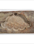 Brown wooden Chinese rice mold with stylized cloud, circular patterns, and radiating lines, close-up view.