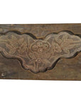 Brown wooden Chinese rice mold with carved three-flower and leaf cloud design, close-up on plain background.