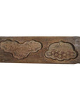 Brown wood antique Chinese rice mold with two carved designs for traditional pastries, close-up on plain background.